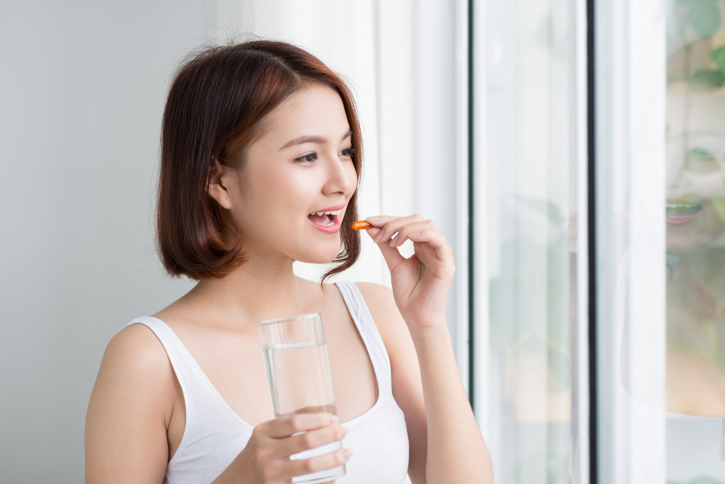 asian woman taking supplements